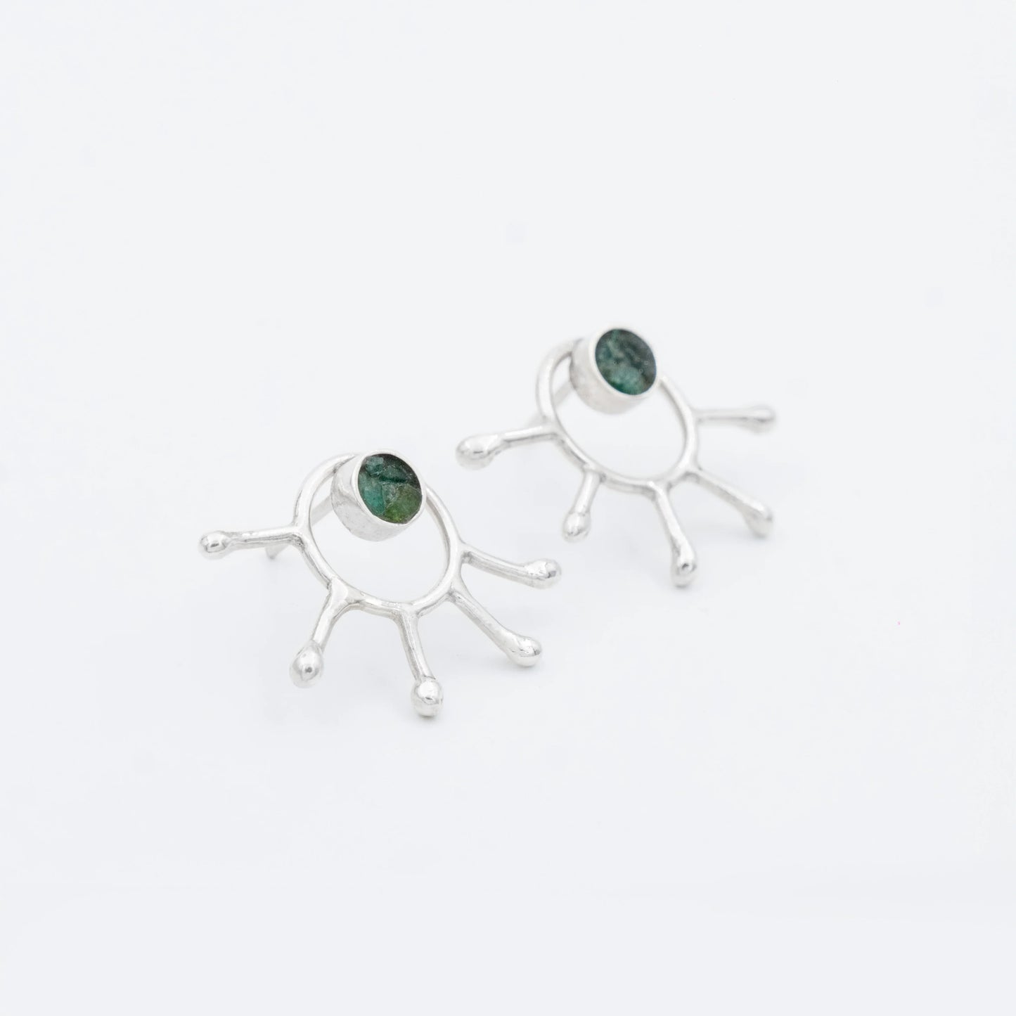 Handmade recycled silver earrings with a unique five-pronged design and Colombian emeralds.