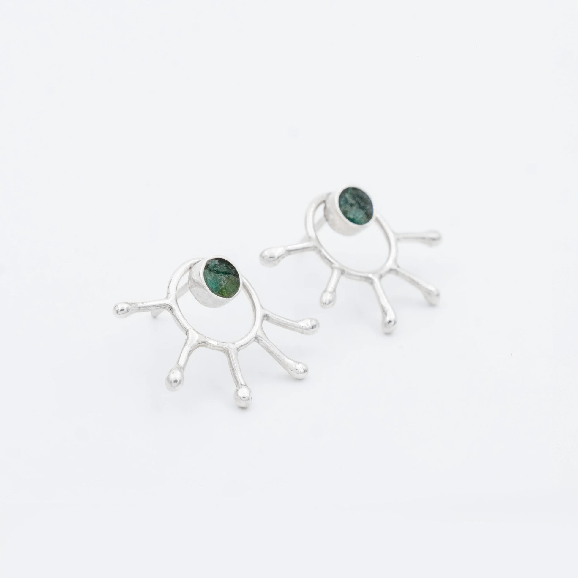 Handmade recycled silver earrings with a unique five-pronged design and Colombian emeralds.