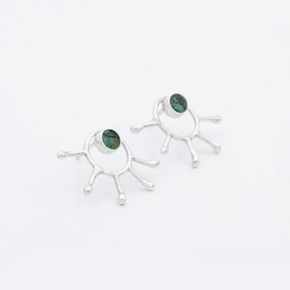 Handmade recycled silver earrings with a unique five-pronged design and Colombian emeralds.