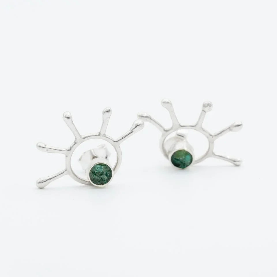 Silver 950 stud earrings with an abstract sunburst design and round Colombian emeralds.