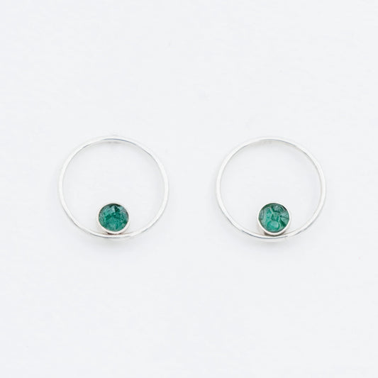 Pair of handmade silver hoop earrings with small, raw Colombian emerald stones.