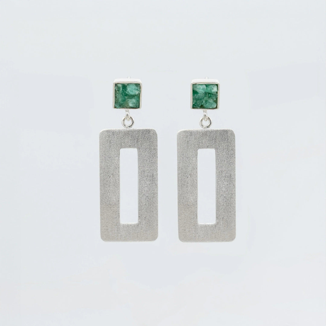 Handmade silver earrings with raw Colombian emerald studs and rectangular dangle design.