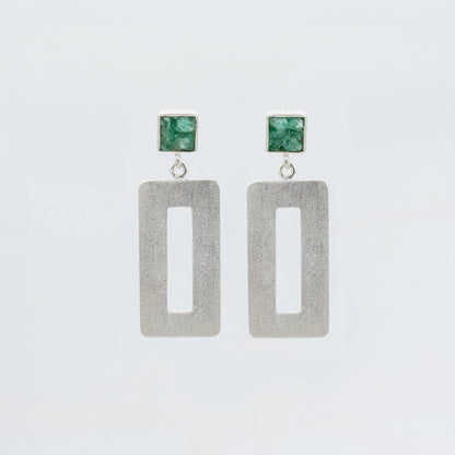 Handmade silver earrings with raw Colombian emerald studs and rectangular dangle design.