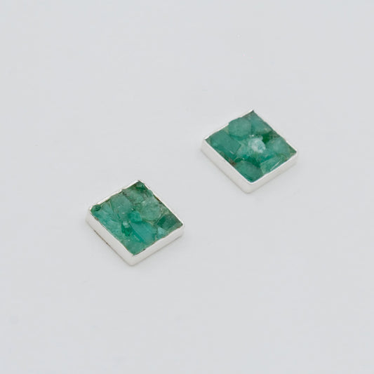Pair of square recycled silver stud earrings with raw Colombian emeralds.
