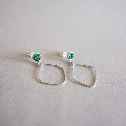 Handmade recycled 950 silver earrings with green Colombian emerald studs and dangling rhombus shapes.