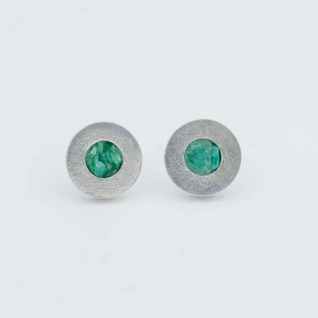 Round textured silver 950 stud earrings with raw Colombian emeralds.