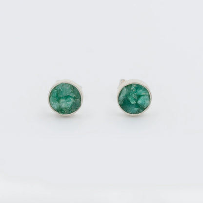 Handmade circular sterling silver 950 stud earrings with raw Colombian emeralds.