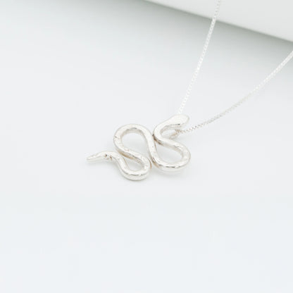 Silver 950 Mamba snake pendant necklace with a textured, handcrafted design on a white background.