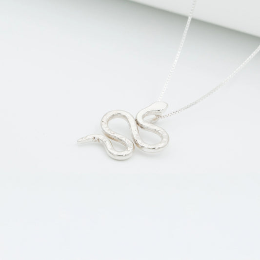 Silver 950 Mamba snake pendant necklace with a textured, handcrafted design on a white background.
