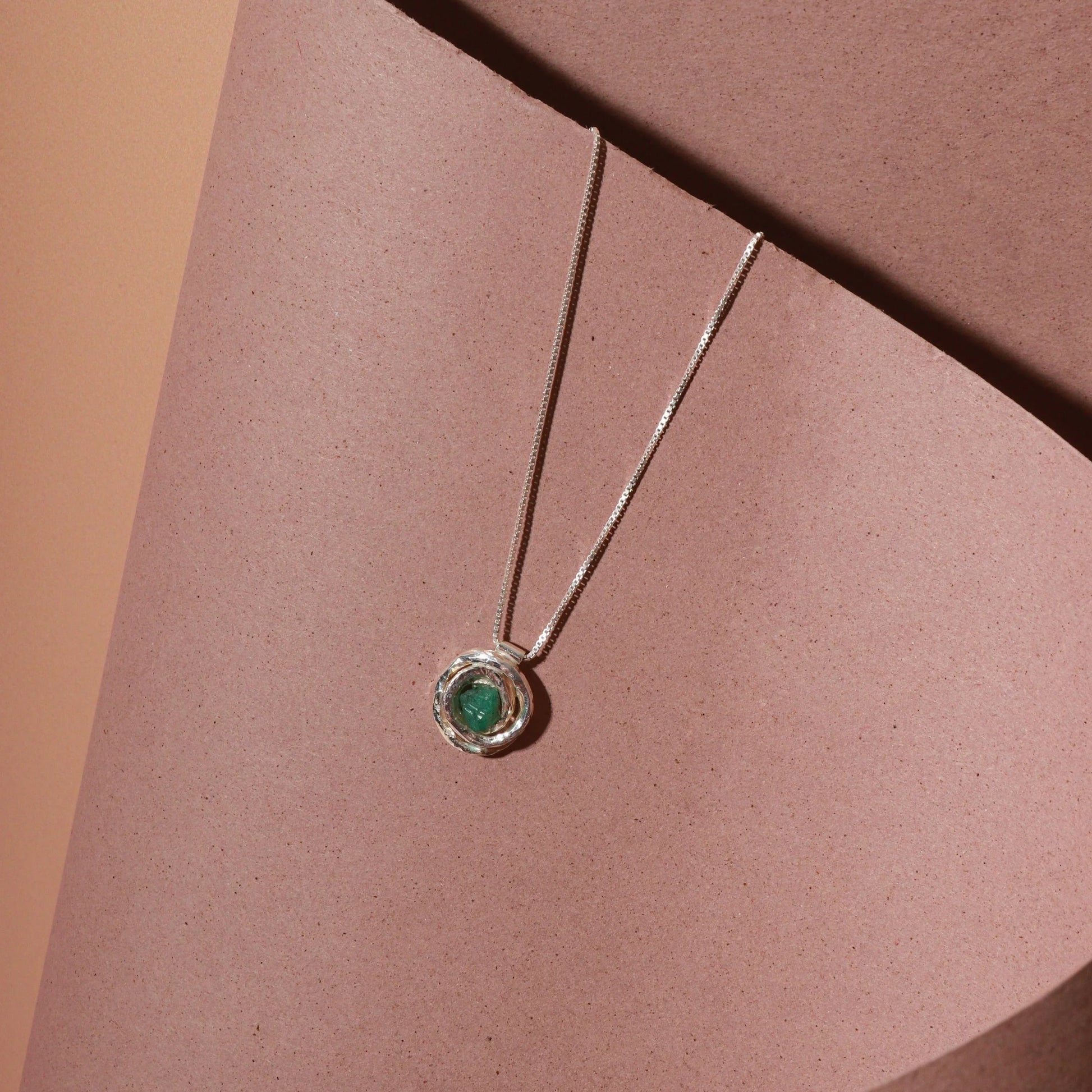 Silver 950 "nest" pendant with a raw Colombian emerald, on a delicate chain.