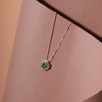 Silver 950 "nest" pendant with a raw Colombian emerald, on a delicate chain.