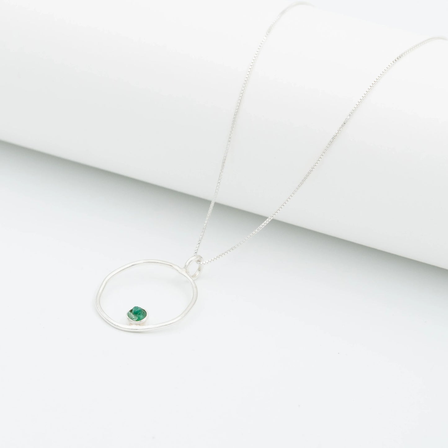 Recycled silver 950 necklace with an organic open circle pendant and a small Colombian emerald.