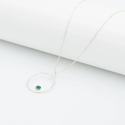 Recycled silver 950 necklace with an organic open circle pendant and a small Colombian emerald.