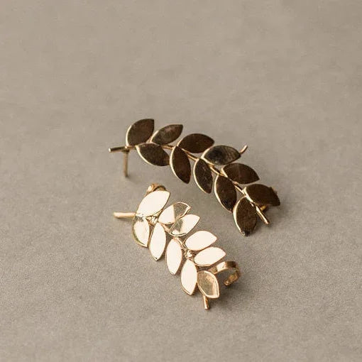 Gold-plated sterling silver ear cuffs shaped like delicate leaf branches.